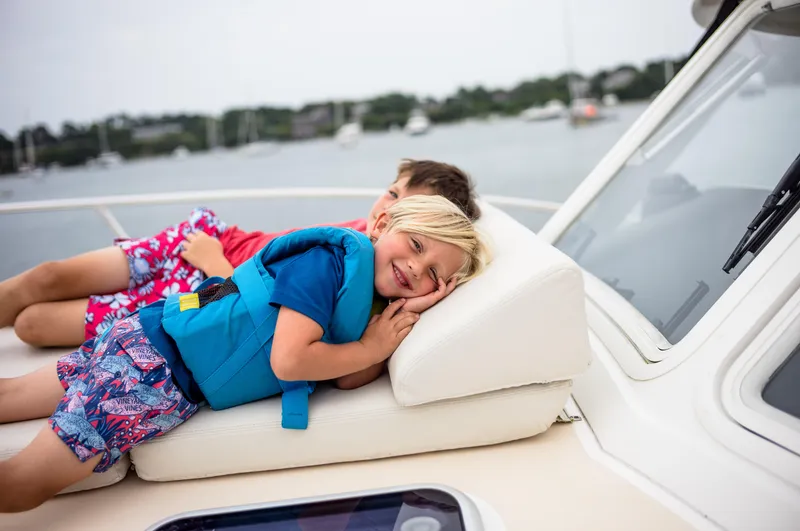 Slide: The Image of Children relaxing on a 2020 MJM 53z boat, enjoying a sunny day on the water. - 6