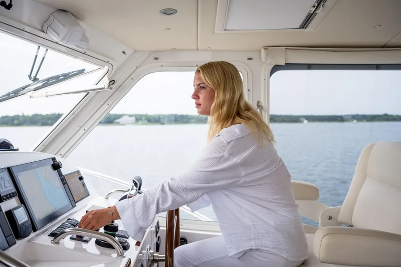 Slide: The Image of Woman piloting 2020 MJM 53z yacht on open water. - 8
