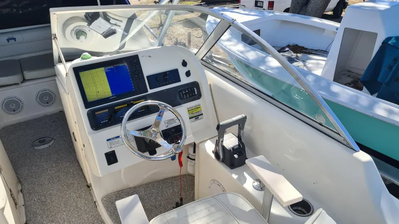 Slide: The Image of 2009 World Cat 250 DC boat cockpit with steering wheel and navigation system. - 10