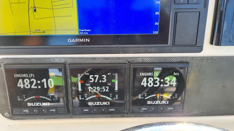 Slide: The Image of Dashboard of a 2009 World Cat 250 DC with Suzuki engine gauges and Garmin display. - 12