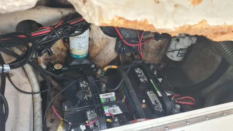 Slide: The Image of Engine compartment of a 2009 World Cat 250 DC with batteries and wiring visible. - 16