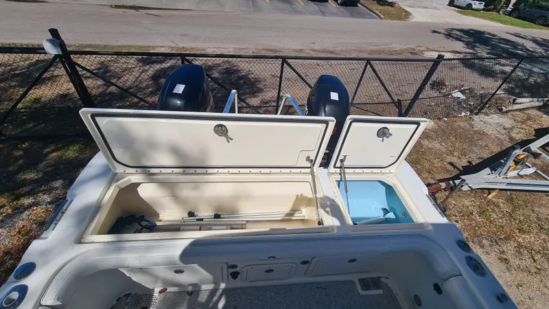 Slide: The Image of 2009 World Cat 250 DC boat with open storage compartments and dual engines. - 20