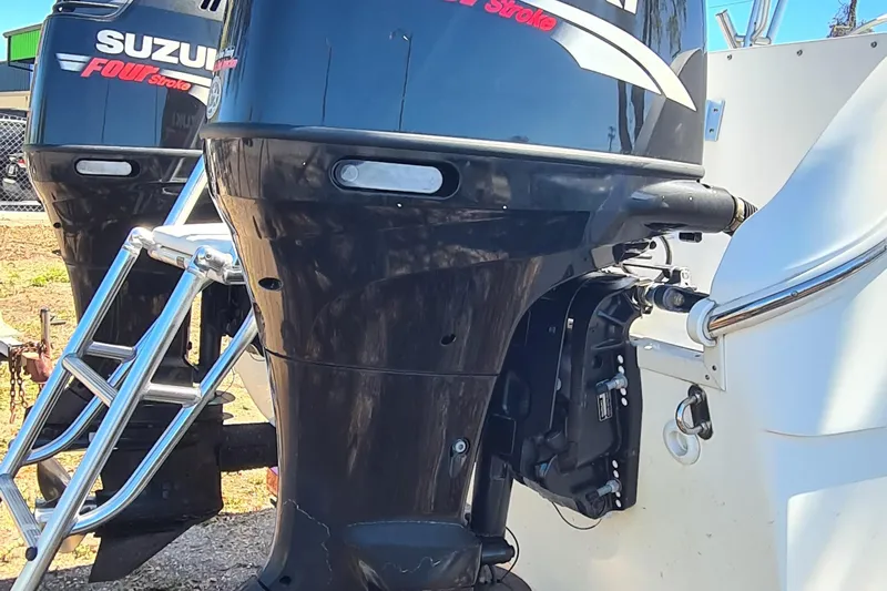 Slide: The Image of 2009 World Cat 250 DC with Suzuki outboard engines and ladder. - 23