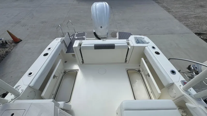 Slide: The Image of 2025 Cobia 240 Dual Console boat interior with seating and storage compartments. - 13