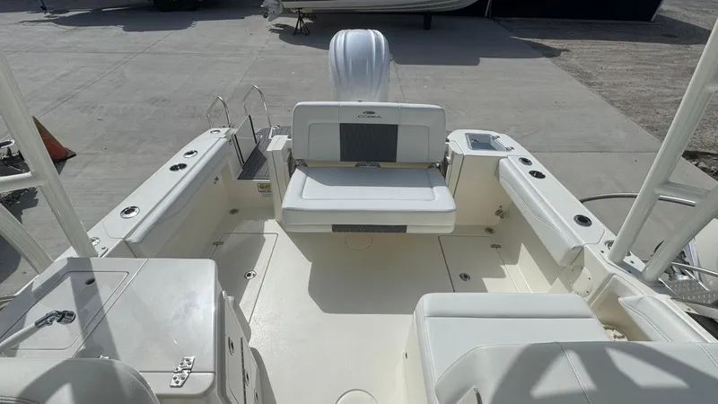 Slide: The Image of 2025 Cobia 240 Dual Console boat interior with seating and storage compartments. - 14