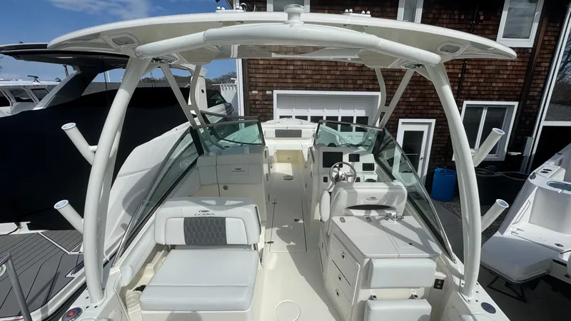 Slide: The Image of 2025 Cobia 240 Dual Console boat with spacious seating and modern design. - 15