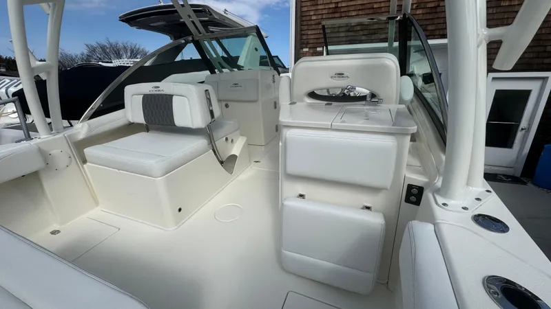 Slide: The Image of 2025 Cobia 240 Dual Console boat interior with seating and storage compartments. - 18