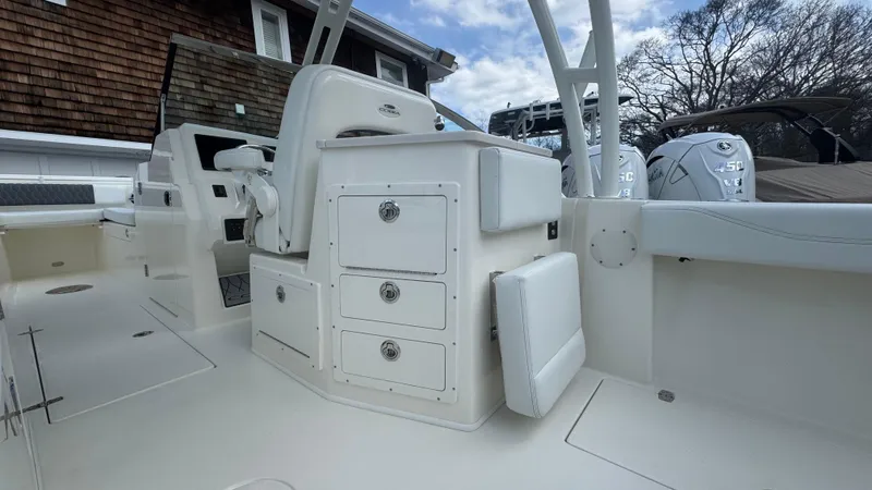 Slide: The Image of 2025 Cobia 240 Dual Console boat interior with storage compartments and seating. - 19