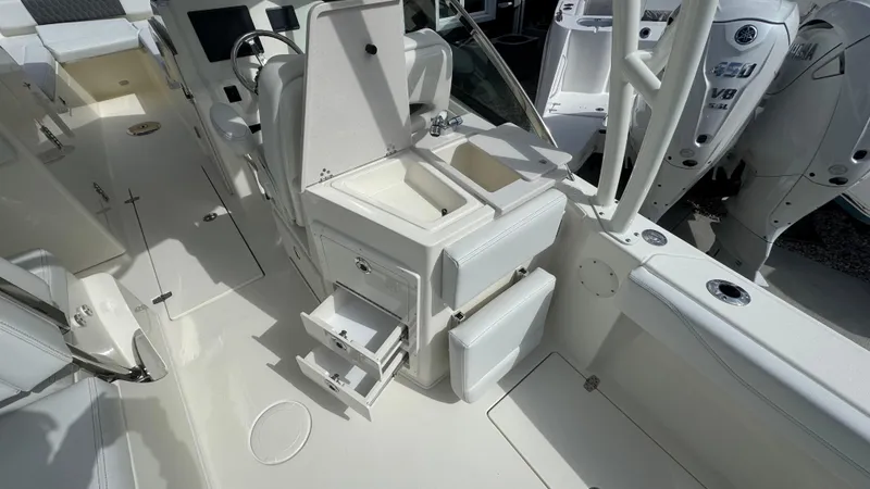 Slide: The Image of 2025 Cobia 240 Dual Console boat interior with seating, storage, and control panel. - 20