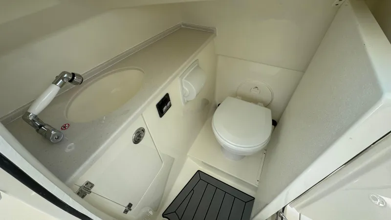 Slide: The Image of 2025 Cobia 240 Dual Console boat bathroom with sink and toilet. - 37