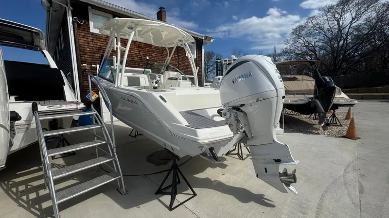 Slide: The Image of 2025 Cobia 240 Dual Console boat with Yamaha outboard motor on display. - 4