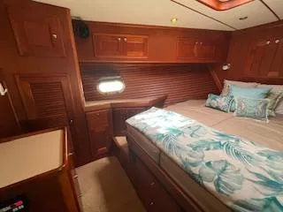 Slide: The Image of Luxurious cabin interior of 2001 Nordhavn 40 yacht with cozy bedding and wooden cabinetry. - 31