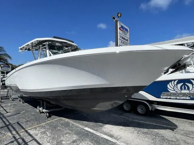 The Image of 2023 Wellcraft 352 Fisherman boat displayed outdoors on a trailer under a clear blue sky. - 1