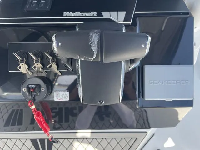Slide: The Image of 2023 Wellcraft 352 Fisherman boat controls with keys and Seakeeper system. - 18