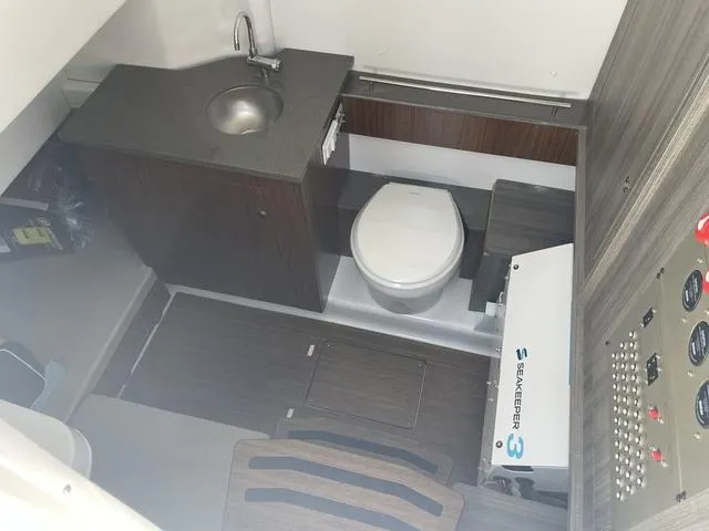 Slide: The Image of 2023 Wellcraft 352 Fisherman boat interior with sink, toilet, and control panel. - 30