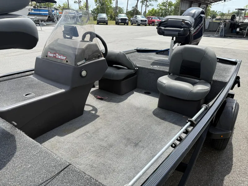 Slide: The Image of 2020 Bass Tracker Classic XL boat interior with seating and steering console. - 5