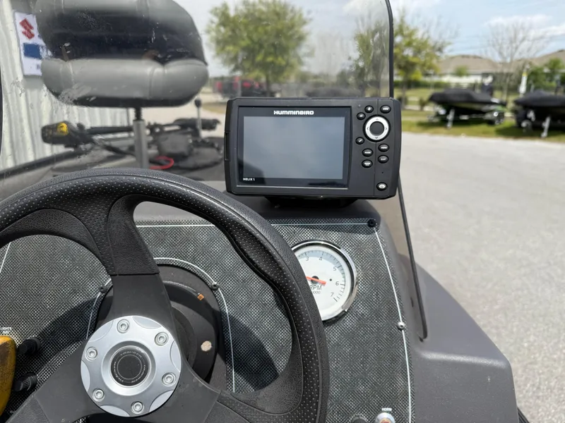 Slide: The Image of Bass Tracker Classic XL 2020 dashboard with steering wheel and fish finder display. - 7