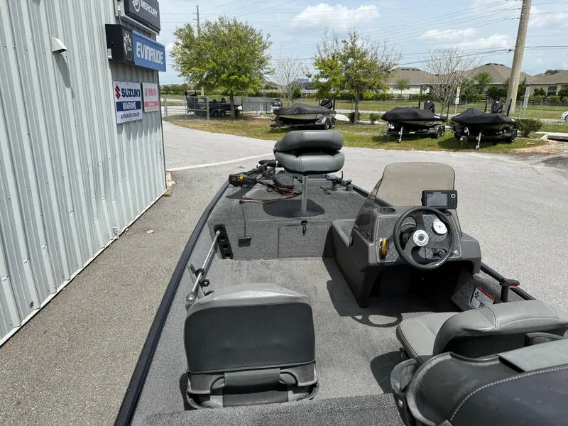Slide: The Image of 2020 Bass Tracker Classic XL boat with seating and steering wheel, parked outdoors. - 8