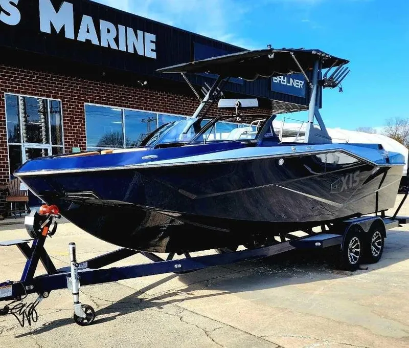 Slide: The Image of 2024 Axis Core Series T235 boat on trailer outside marine store. - 10