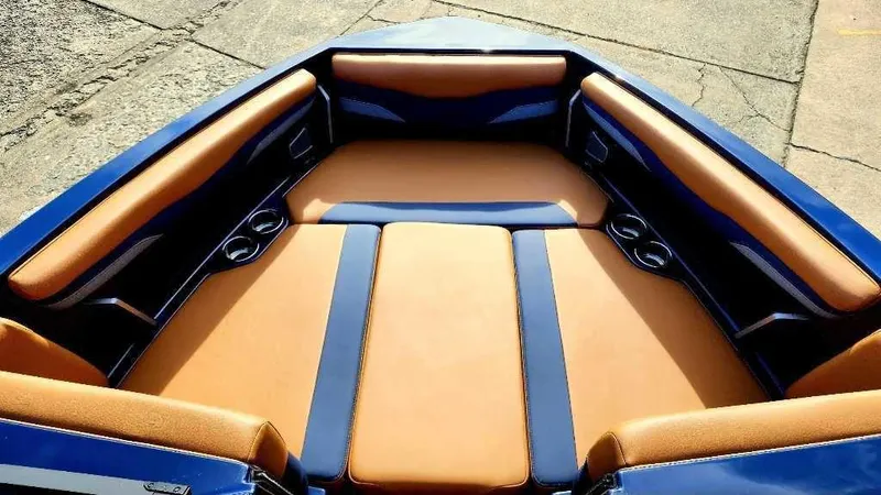 Slide: The Image of 2024 Axis Core Series T235 boat interior with tan and blue seating. - 9