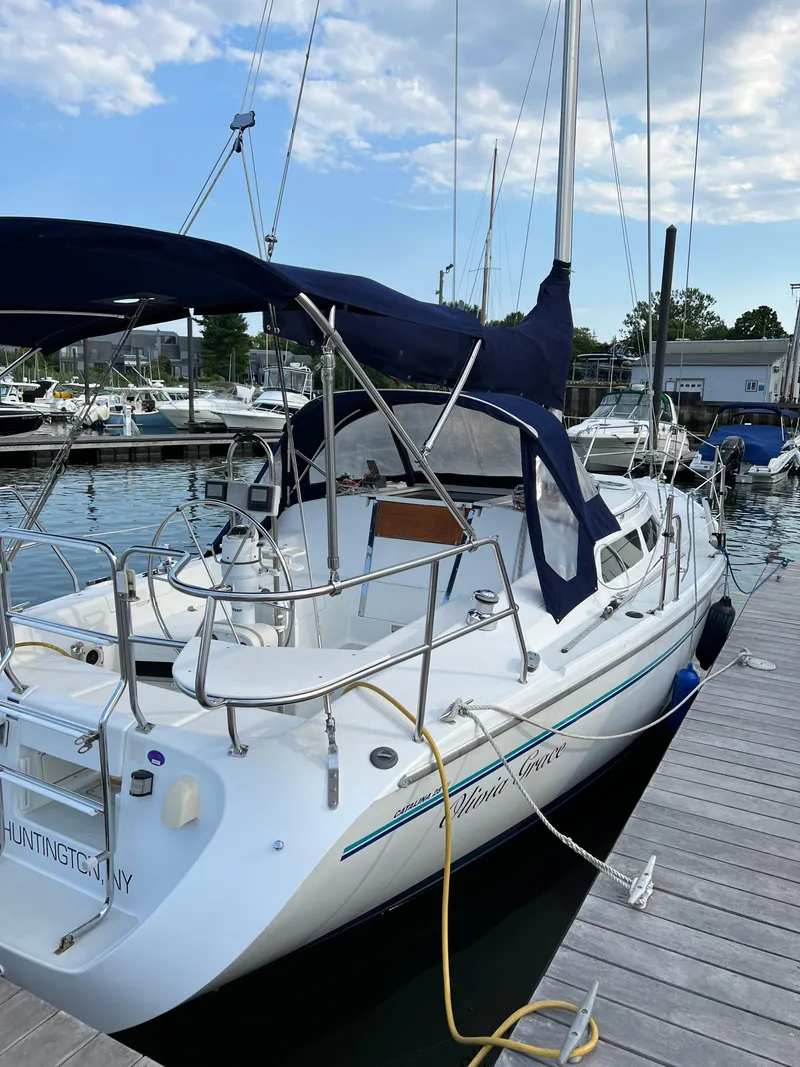 Slide: The Image of 1997 Catalina 28 MkII sailboat docked at marina with blue canopy. - 1