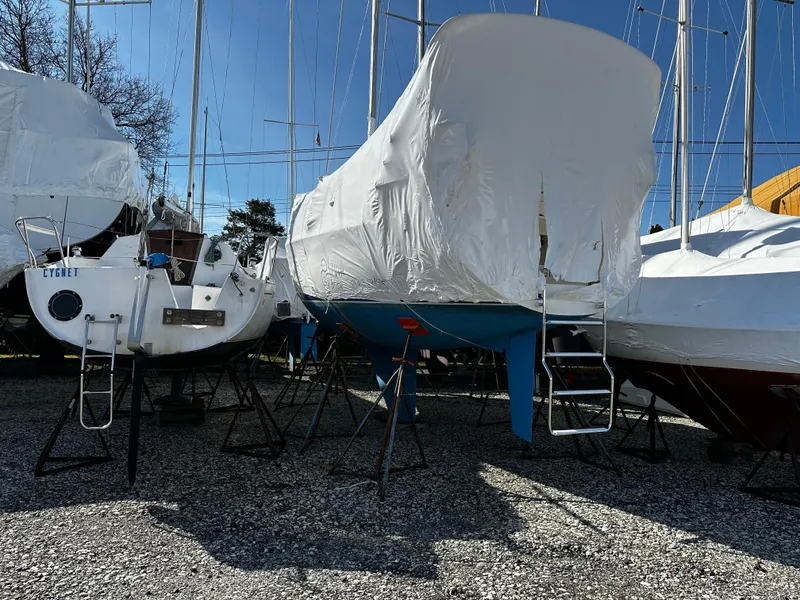 Slide: The Image of 1997 Catalina 28 MkII sailboat covered in white tarp, stored on stands. - 10