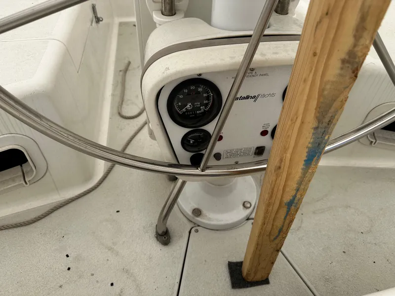 Slide: The Image of 1997 Catalina 28 MkII sailboat cockpit with steering wheel and control panel. - 12