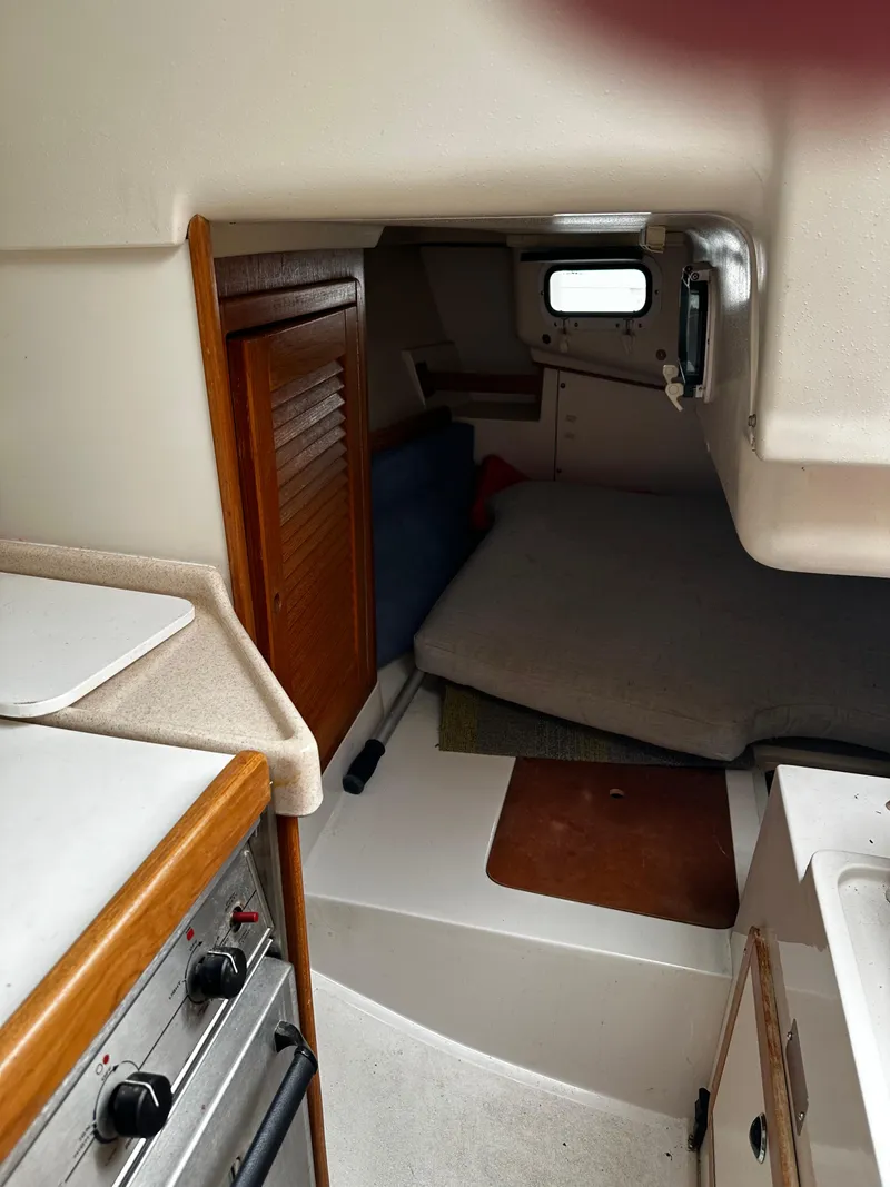 Slide: The Image of Interior of a 1997 Catalina 28 MkII sailboat, featuring a compact cabin space. - 17