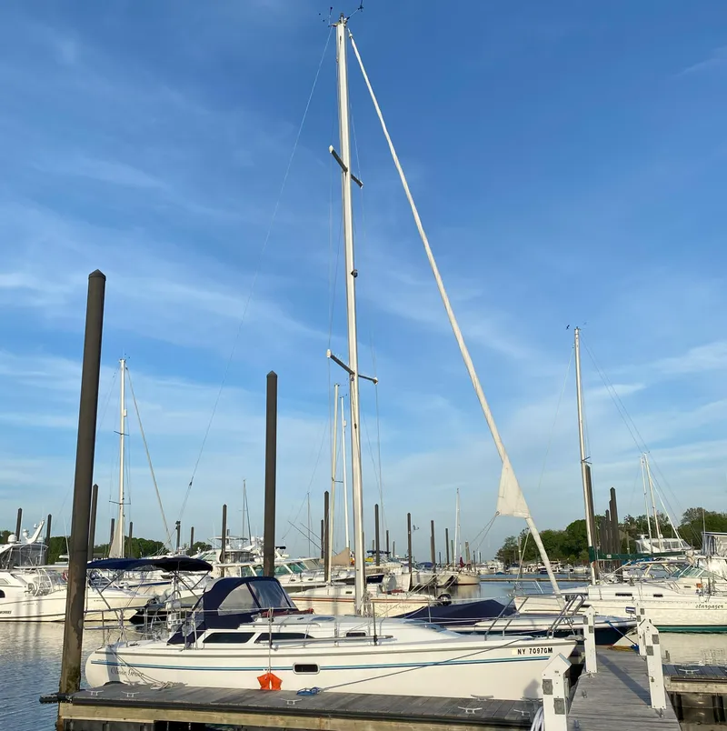 Slide: The Image of 1997 Catalina 28 MkII sailboat docked at marina under clear blue sky. - 21