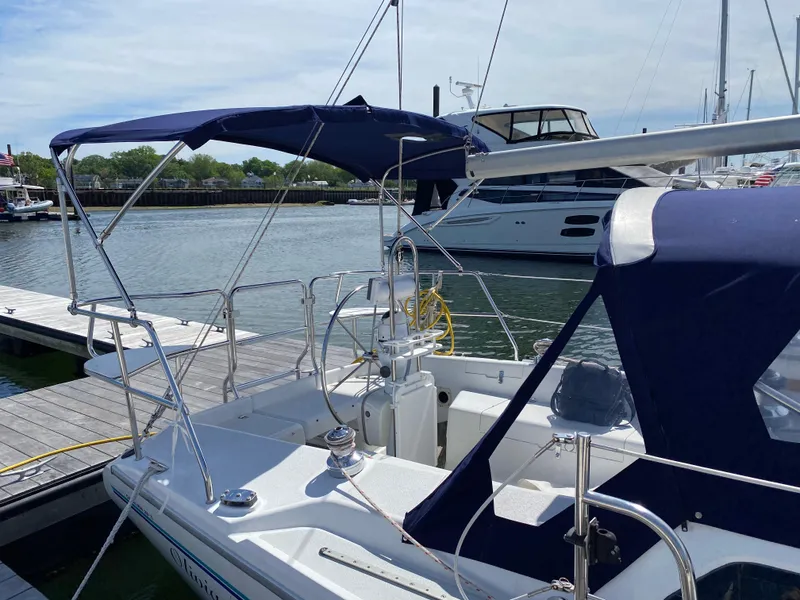 Slide: The Image of 1997 Catalina 28 MkII sailboat docked, featuring blue canvas covers and a spacious cockpit. - 3