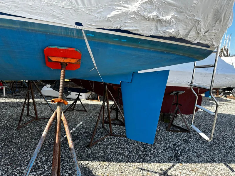 Slide: The Image of Catalina 28 MkII 1997 sailboat on stands, showing blue hull and rudder. - 9