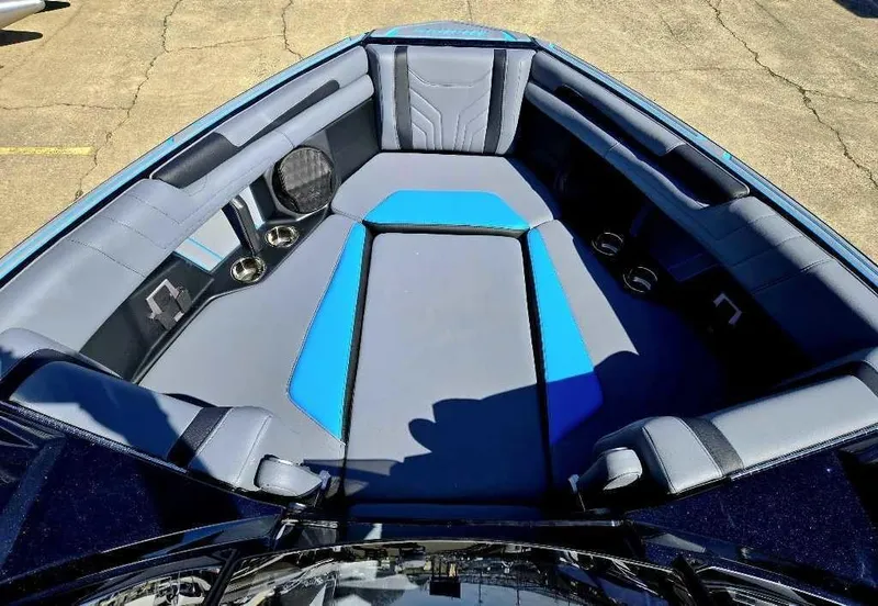 Slide: The Image of 2025 Malibu Wakesetter 25 LSV boat interior with blue and gray seating. - 11