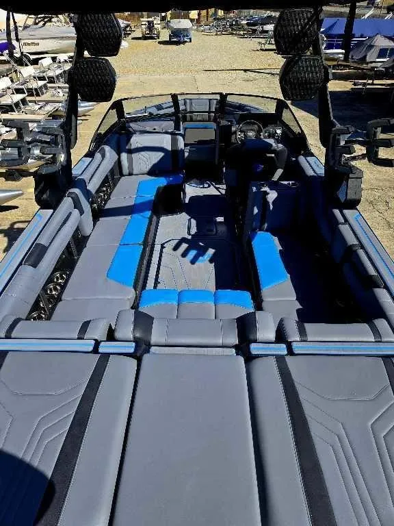 Slide: The Image of 2025 Malibu Wakesetter 25 LSV interior with blue and gray seating, showcasing spacious design. - 14