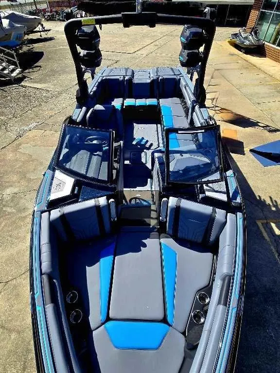 Slide: The Image of 2025 Malibu Wakesetter 25 LSV boat with sleek blue and gray interior design. - 5