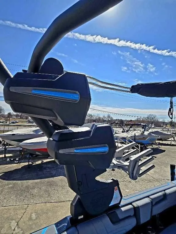 Slide: The Image of 2025 Malibu Wakesetter 25 LSV boat with advanced wakeboard rack under clear blue sky. - 6