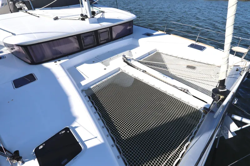 Slide: The Image of 2017 Lagoon 450 F catamaran deck with netting, sailing on calm waters. - 12