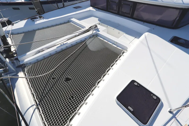 Slide: The Image of 2017 Lagoon 450 F catamaran deck with netting and hatches. - 13