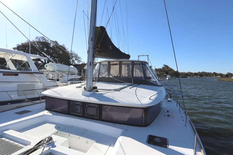 Slide: The Image of 2017 Lagoon 450 F catamaran docked by the water on a sunny day. - 15