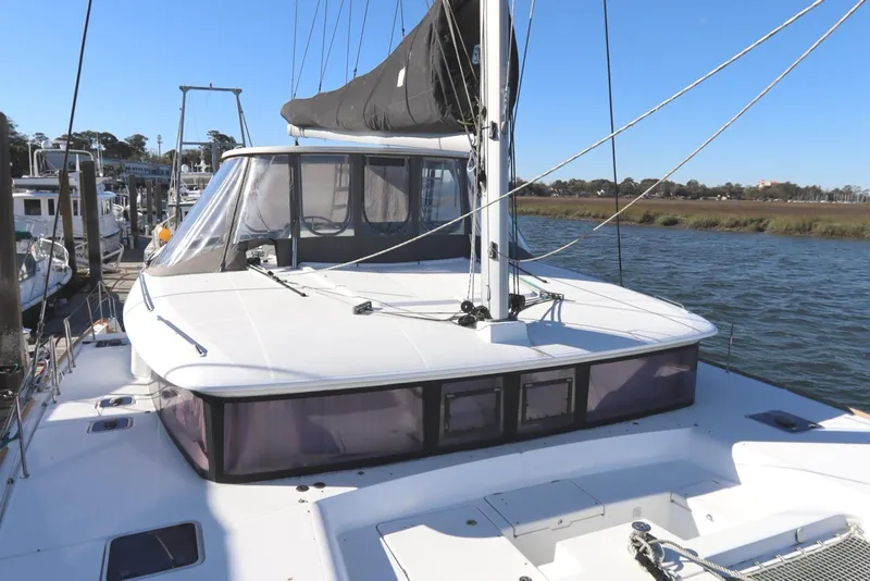 Slide: The Image of 2017 Lagoon 450 F catamaran docked, featuring sleek design and spacious deck. - 16
