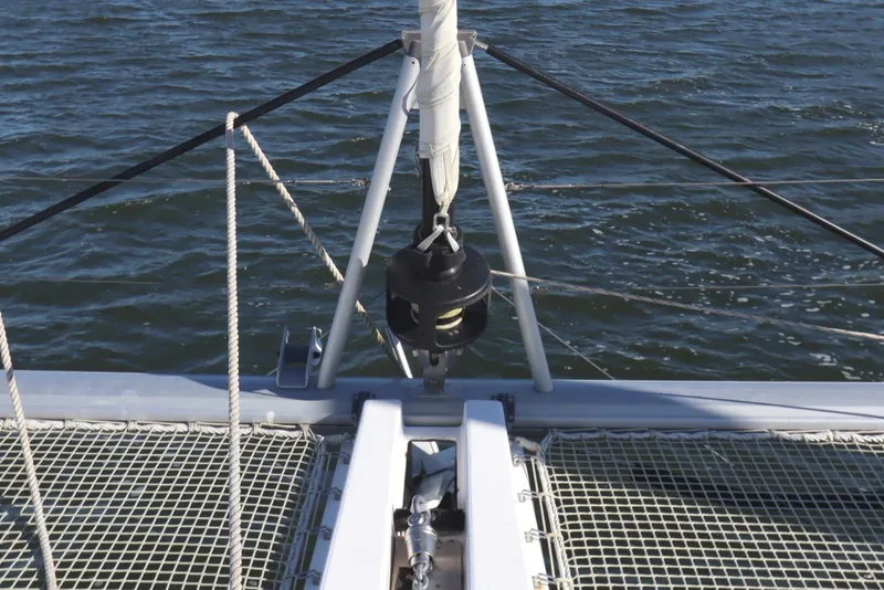 Slide: The Image of Bow of 2017 Lagoon 450 F catamaran with netting over water. - 17