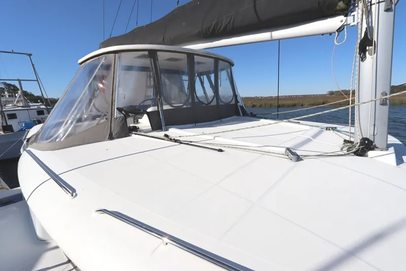 Slide: The Image of 2017 Lagoon 450 F catamaran with enclosed cockpit, docked on a sunny day. - 19
