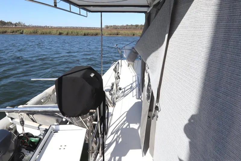 Slide: The Image of 2017 Lagoon 450 F yacht deck with covered equipment, moored on calm water. - 25