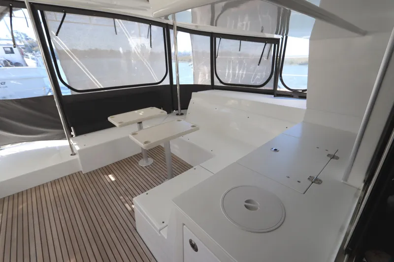 Slide: The Image of 2017 Lagoon 450 F yacht interior with seating and tables, featuring sleek design and ample natural light. - 27