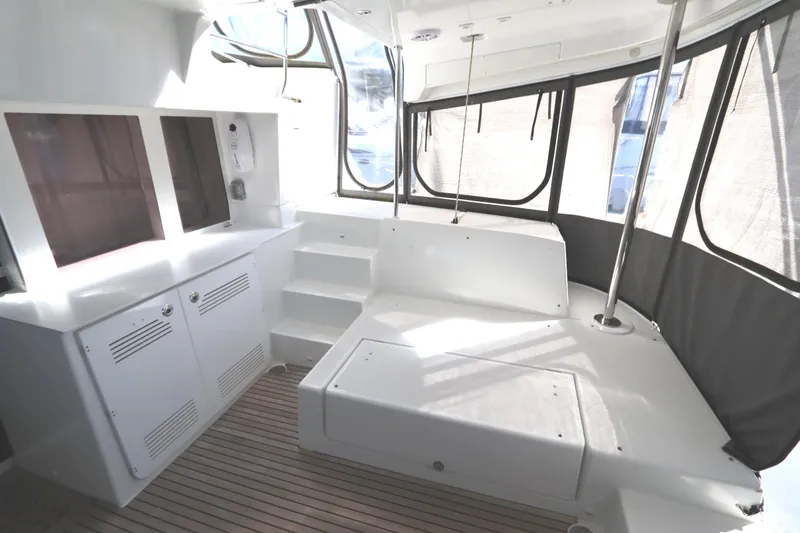Slide: The Image of 2017 Lagoon 450 F yacht interior with sleek white design and spacious seating area. - 29