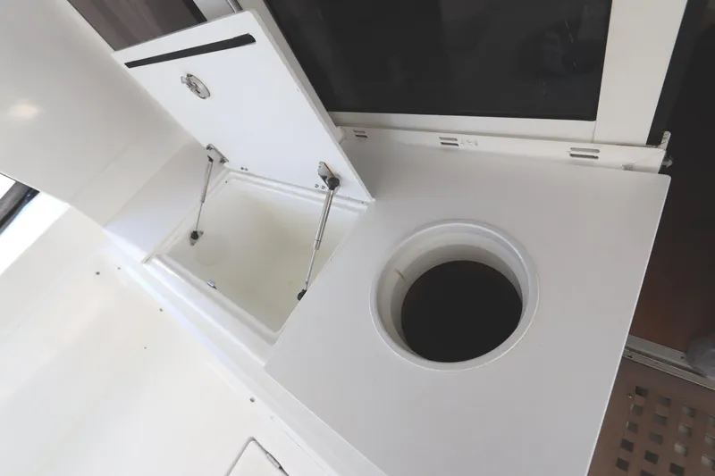 Slide: The Image of Lagoon 450 F 2017 yacht interior with open storage compartments and circular access hatch. - 39