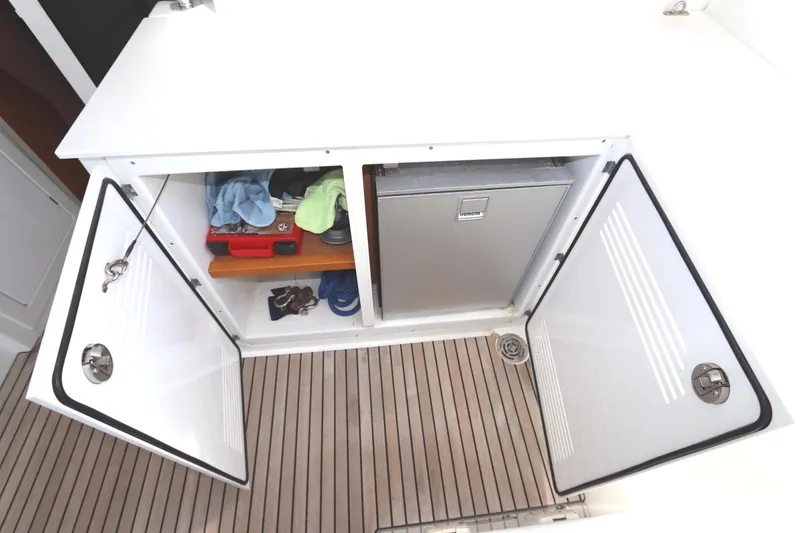 Slide: The Image of Storage compartment on 2017 Lagoon 450 F yacht with open doors and visible items. - 40