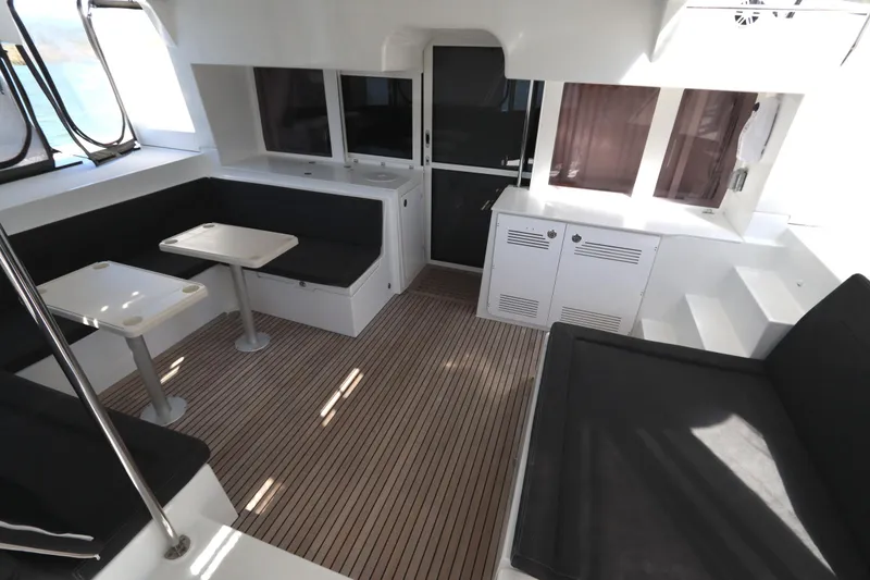 Slide: The Image of Interior of 2017 Lagoon 450 F catamaran with seating, tables, and wood flooring. - 41