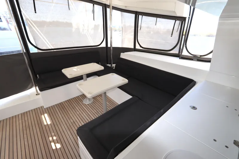 Slide: The Image of 2017 Lagoon 450 F yacht interior with seating and tables, featuring sleek design and ample windows. - 42