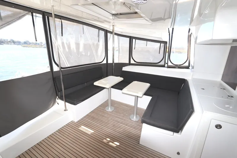 Slide: The Image of Interior of 2017 Lagoon 450 F catamaran with seating and tables, featuring modern design. - 43