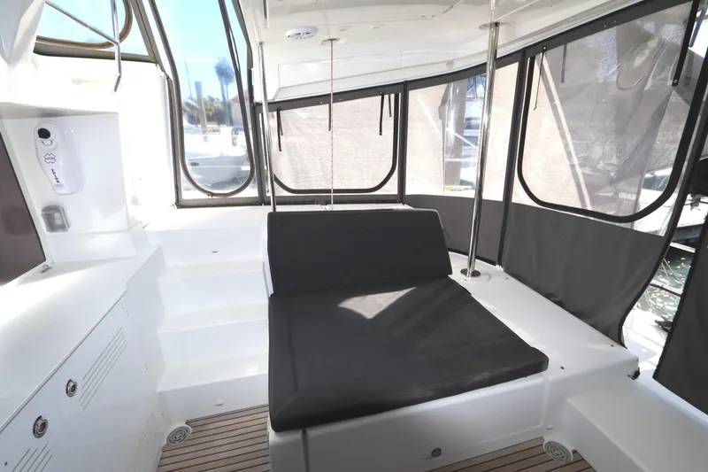 Slide: The Image of 2017 Lagoon 450 F yacht interior with cushioned seating and panoramic windows. - 44